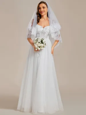 Robe de mariée romantique en dentelle transparente avec corsage et bretelles spaghetti à manches courtes en tulle